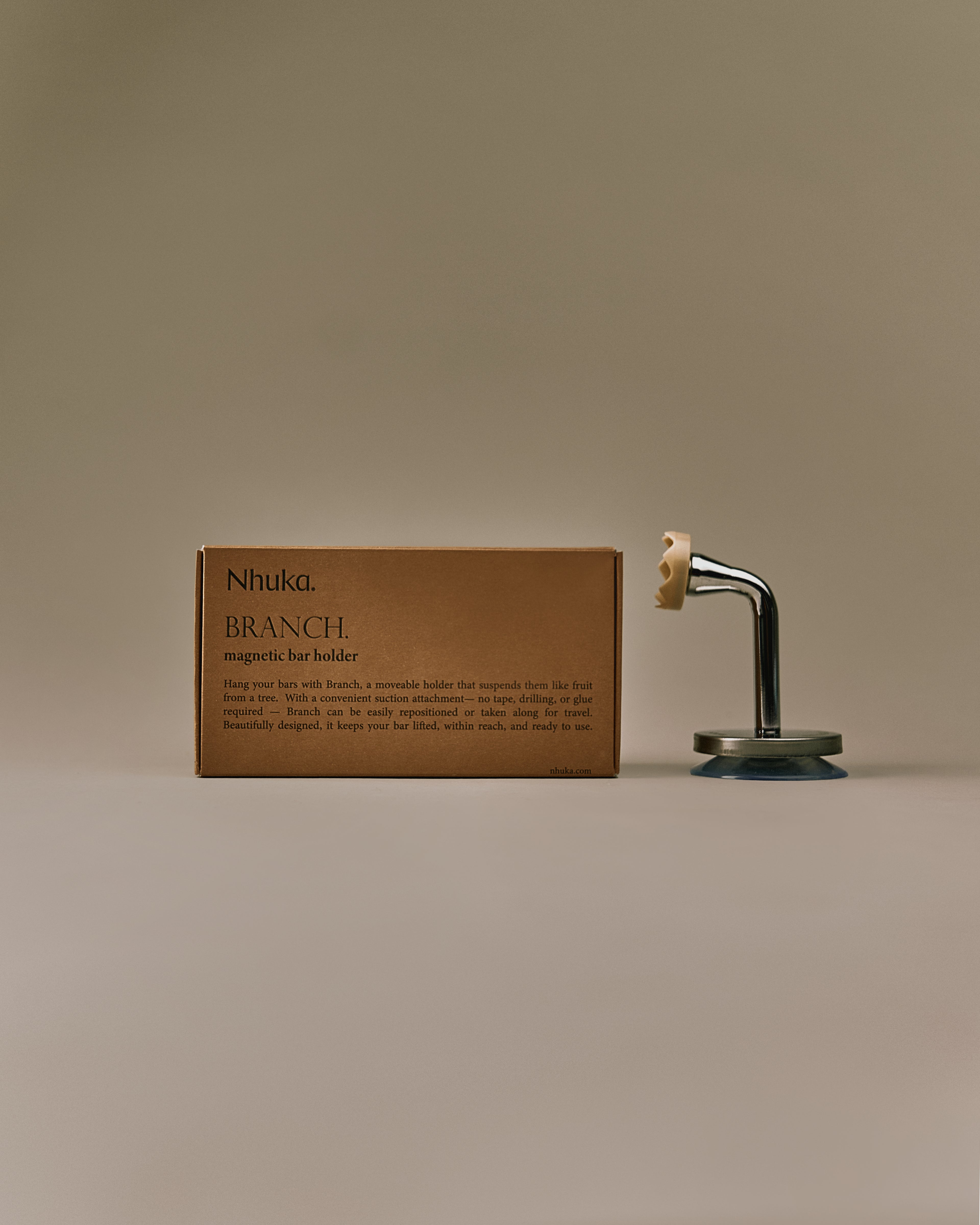 Nhuka Branch magnetic bar holder with packaging. Features suction cap base and chrome stem. Designed to suspend bars like fruit from a tree. No glue or drilling required.