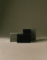 Nhuka Charcoal One Bar packaged in FSC-certified paper. Handmade in Australia, pH-balanced, sulfate-free, silicone-free, and organic. Warming chai scent with cinnamon, ginger, and nutmeg. Exfoliating formula with pumice, designed for hair, face, and body.