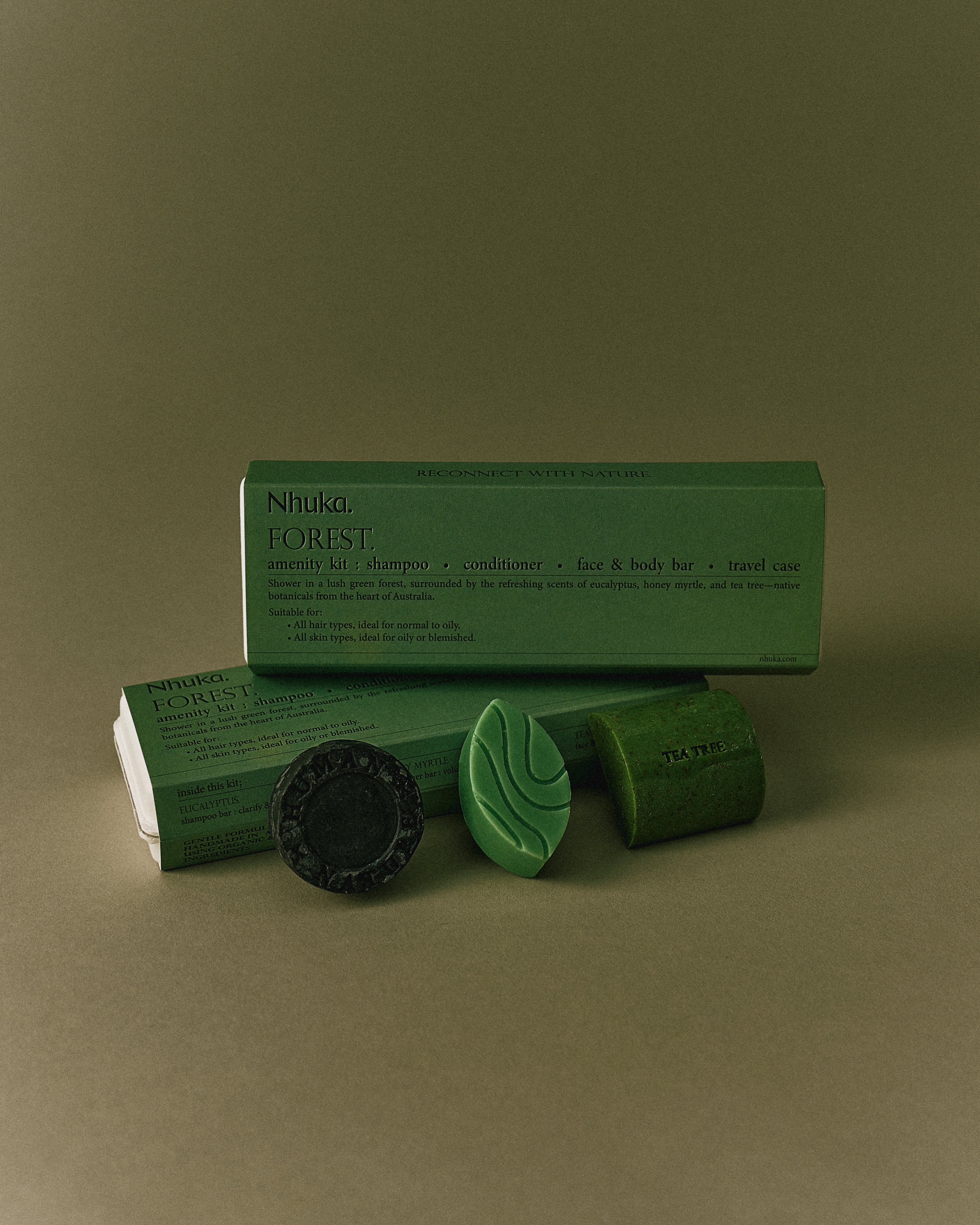 Nhuka Forest Amenity Kit with shampoo, conditioner, face & body bar, and packaging. Fresh green scents with eucalyptus, honey myrtle and tea tree. Ideal for normal to oily hair and skin types.