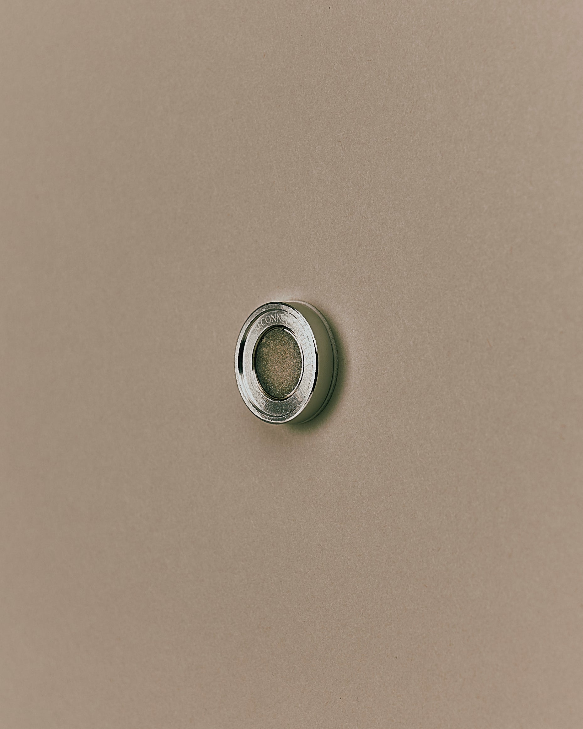 Nhuka Stem magnetic bar holder shown from the side. Made from stainless steel and aluminium, it mounts with 3M tape to keep bars dry and extend their life.