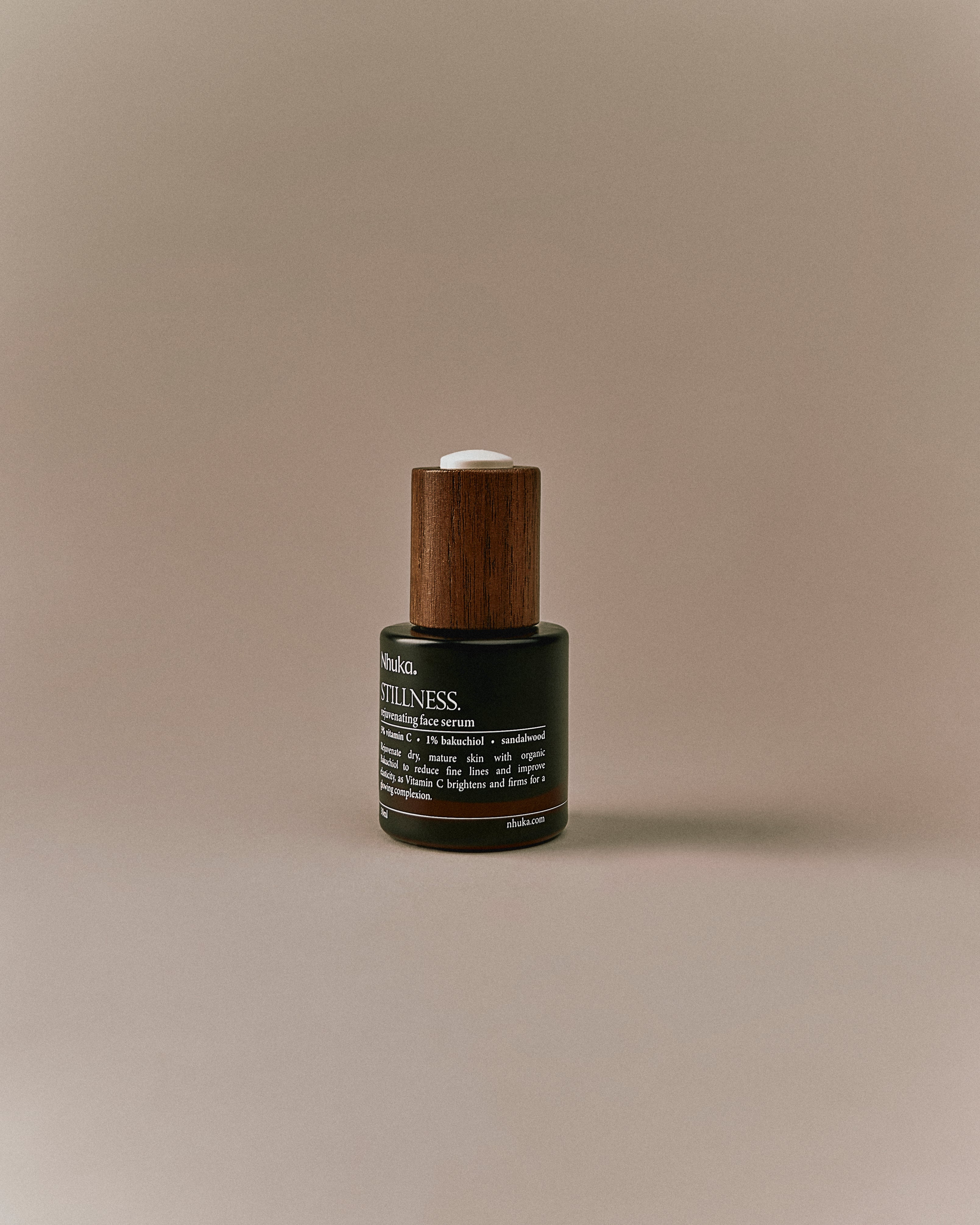 Nhuka Stillness Face Serum bottle with label visible. A rejuvenating serum with 1% bakuchiol oil and 5% vitamin C to support skin radiance and reduce fine lines. Handmade in Australia.