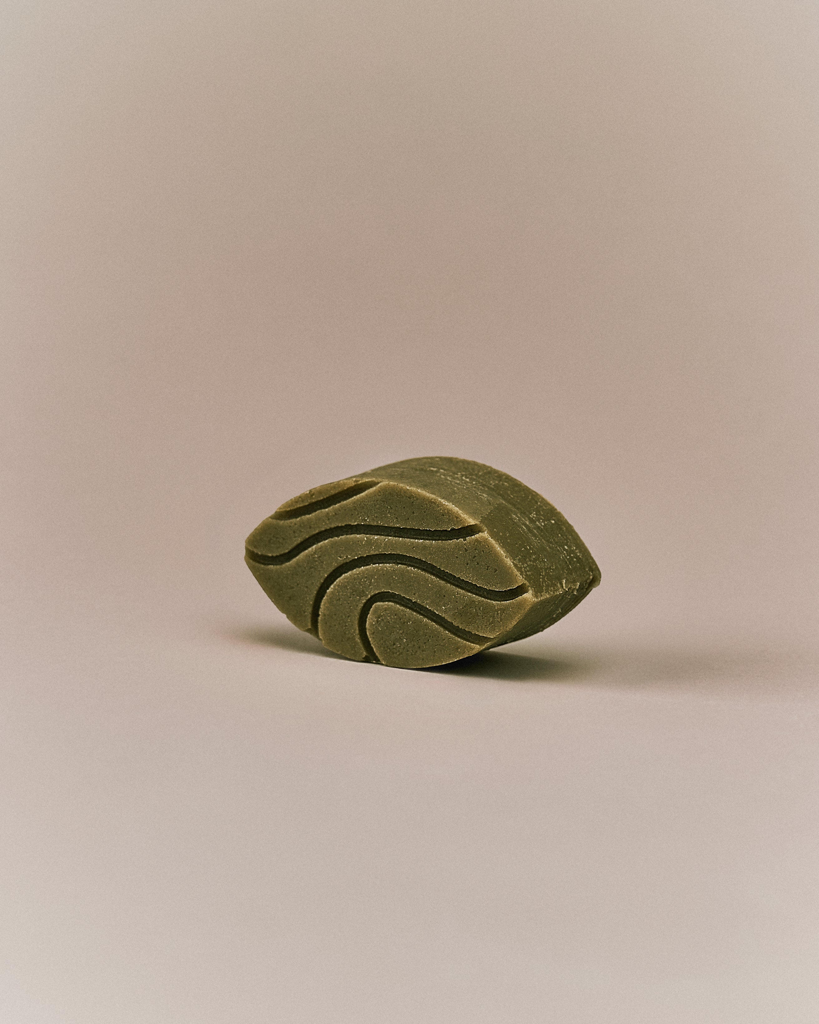 Nhuka Tea Tree conditioner bar shown at an angle. Handmade in Australia, sulfate- and silicone-free, pH-balanced to soothe itchy scalps and add shine.