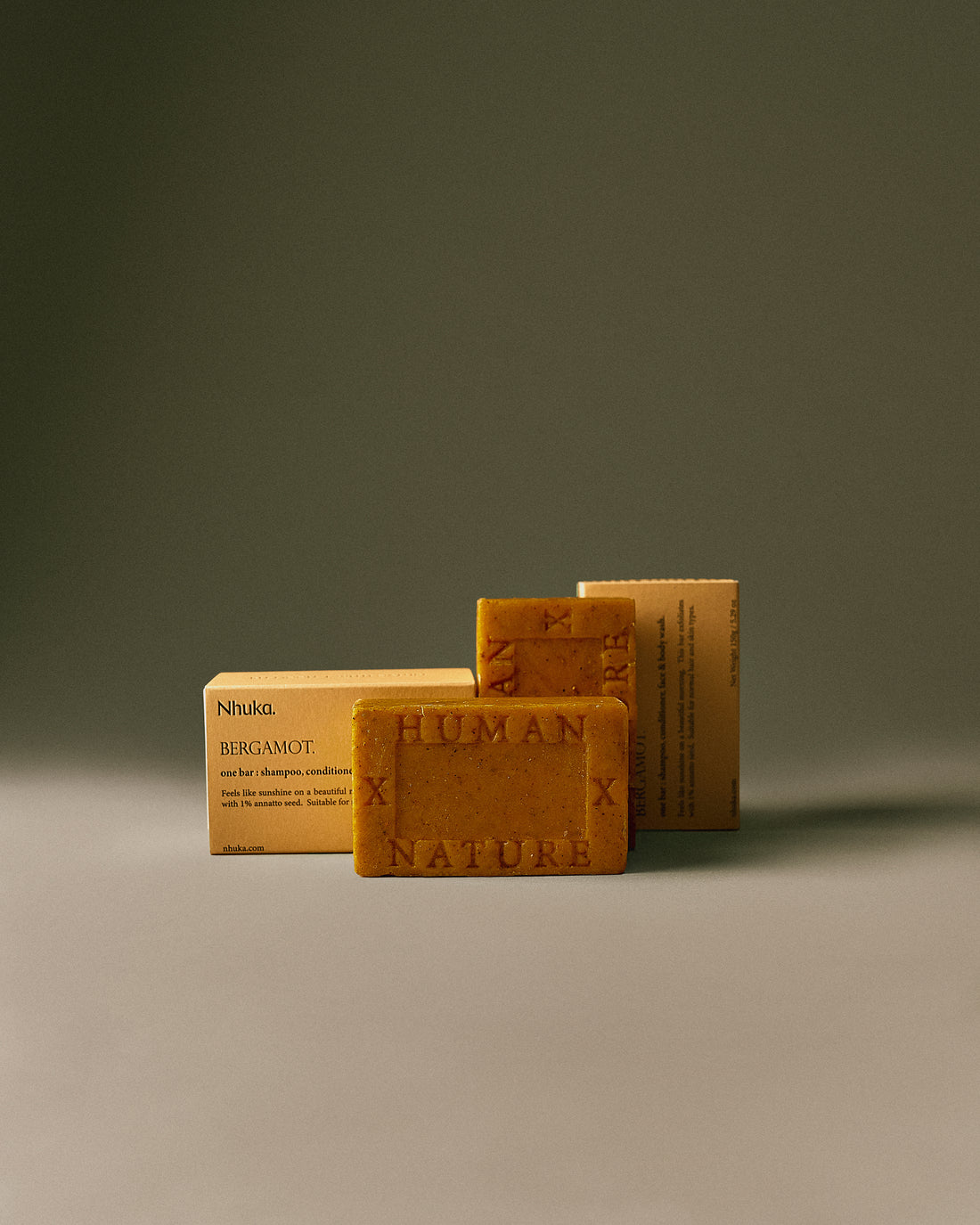 Nhuka Bergamot One Bar with sustainable packaging. Handmade in Australia, pH-balanced, sulfate-free, silicone-free, and organic. Bright citrus scent with exfoliating annatto seed. Designed for cleansing and refreshing hair, face, and body.