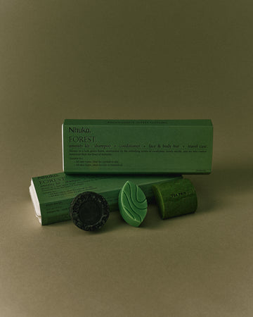 Nhuka Forest Amenity Kit with shampoo, conditioner, face & body bar, and packaging. Fresh green scents with eucalyptus, honey myrtle and tea tree. Ideal for normal to oily hair and skin types.