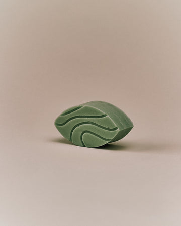 Nhuka Honey Myrtle conditioner bar shown at an angle with botanical swirl design. Handmade in Australia, silicone-free, pH-balanced, and made with organic ingredients for lightweight hydration and shine.
