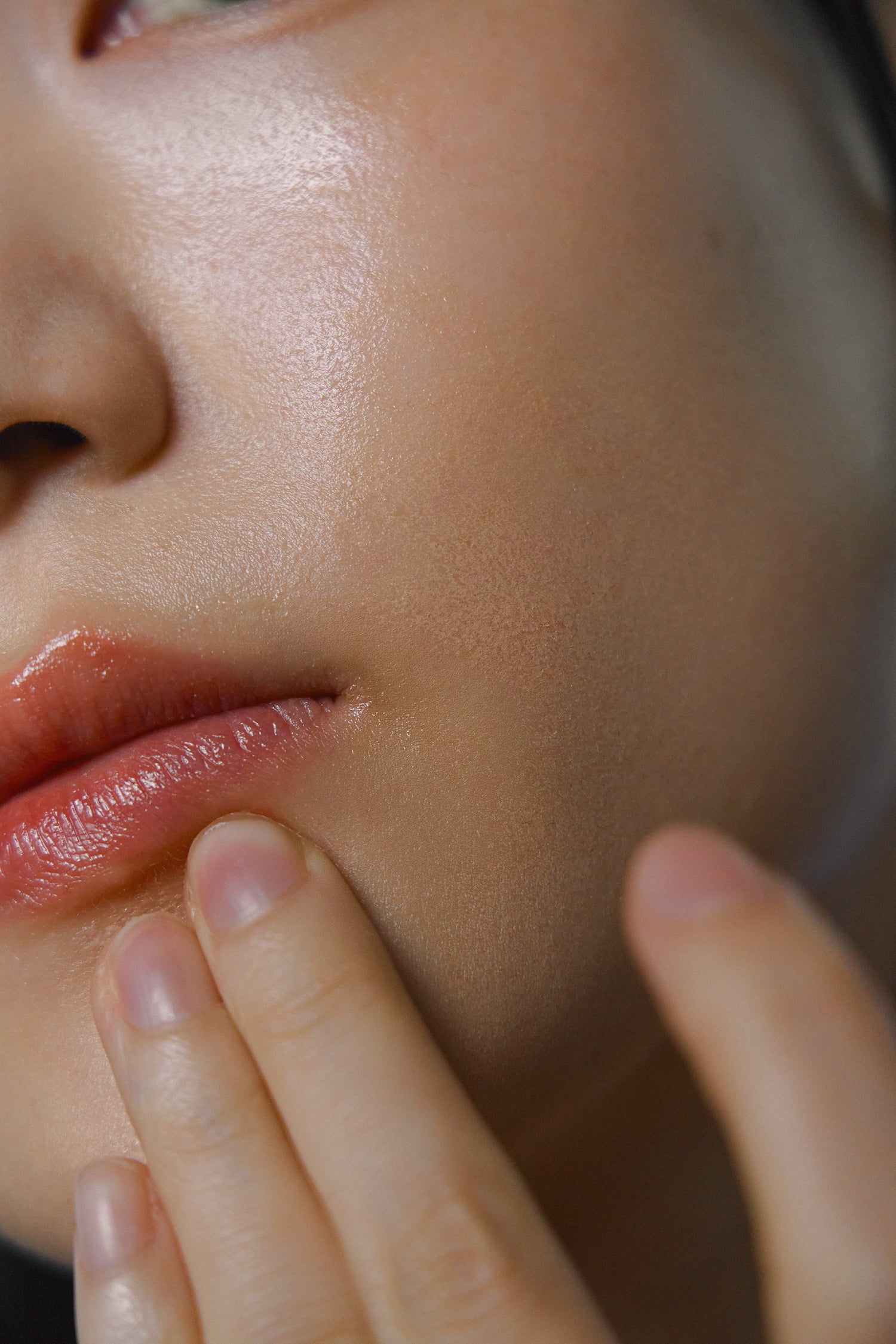 Model after applying Nhuka Oak Moss Multi Balm to lips. Multipurpose balm for dry or sensitive areas like lips, hands, or face. Light, silky texture with subtle earthy scent.
