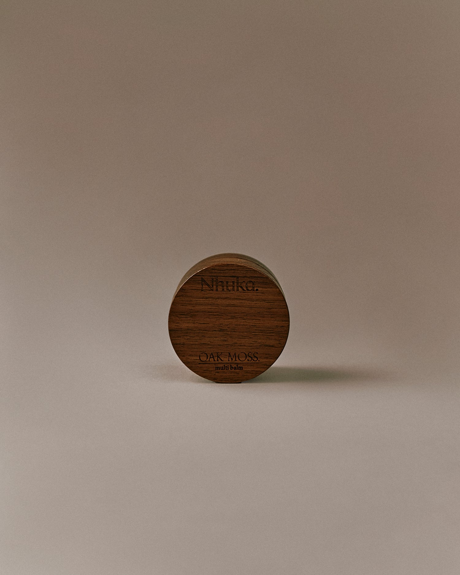 Nhuka Oak Moss Multi Balm front-facing image. A light, silky balm made with organic mango butter, rosehip and passionfruit oils. Soothes dry or sensitive skin. Earthy oak moss scent with subtle green notes.