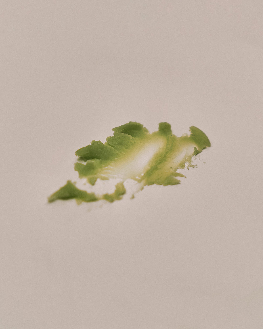 Close-up of Nhuka Oak Moss Multi Balm texture. Soft, lightweight balm formulated with organic mango butter, rosehip oil, and passionfruit oil for nourishing dry skin.