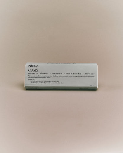 Oasis Amenity Kit with shampoo, conditioner, face &amp; body bar, and travel case. Features frankincense, jasmine, and lemon myrtle. Ideal for dry, curly hair and sensitive or combination skin.