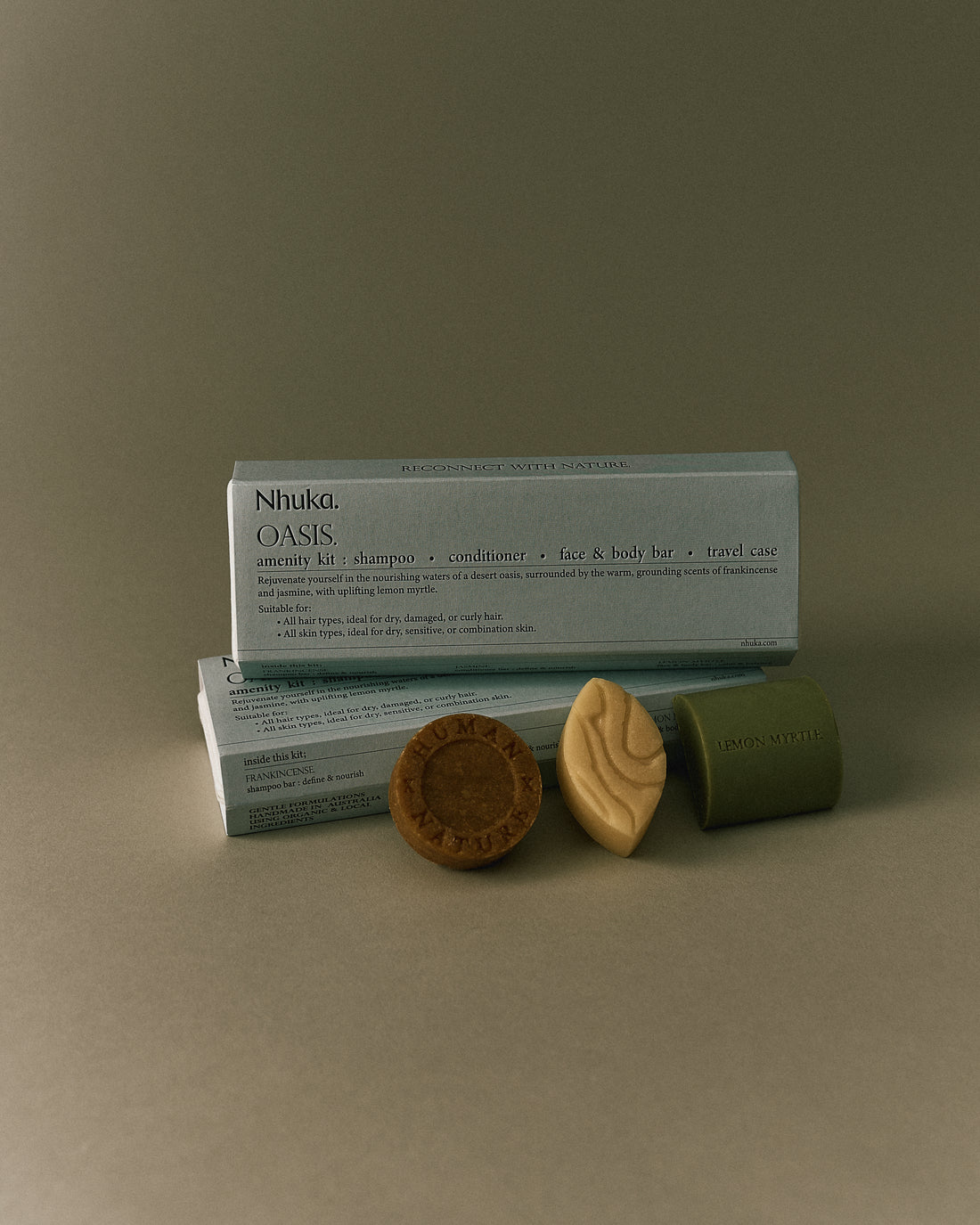 Nhuka Oasis Amenity Kit with shampoo, conditioner, face &amp; body bar, and packaging. Warm tones with frankincense and jasmine. Ideal for dry, curly hair and normal to sensitive skin.
