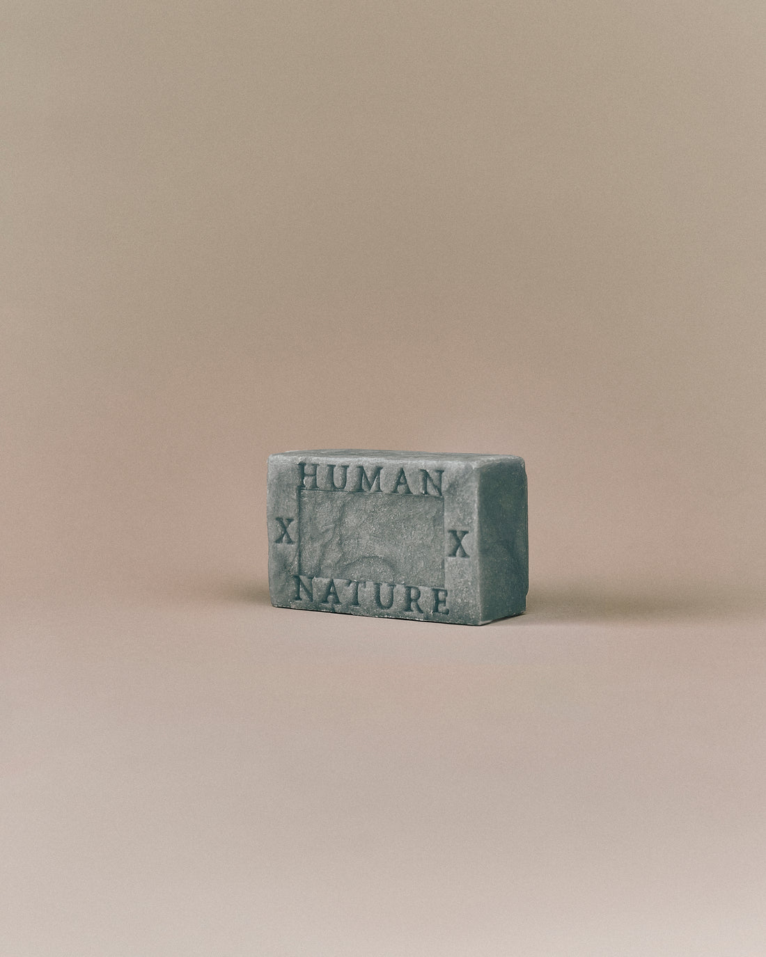 Nhuka Ocean One Bar angled view with Human x Nature emboss. Handmade in Australia, pH-balanced, sulfate-free, silicone-free, and organic. Features cooling menthol and a refreshing scent for hair, face, and body.