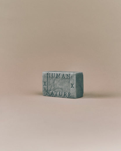 Nhuka Ocean One Bar angled view with Human x Nature emboss. Handmade in Australia, pH-balanced, sulfate-free, silicone-free, and organic. Features cooling menthol and a refreshing scent for hair, face, and body.