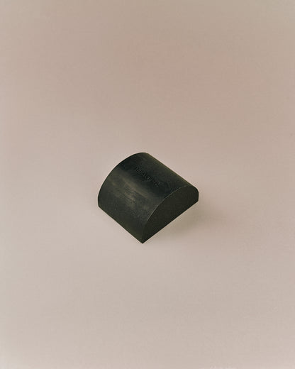 Nhuka organic eucalyptus soap bar shown unwrapped at an angle. Solid bar for face and body, handmade with native botanicals.