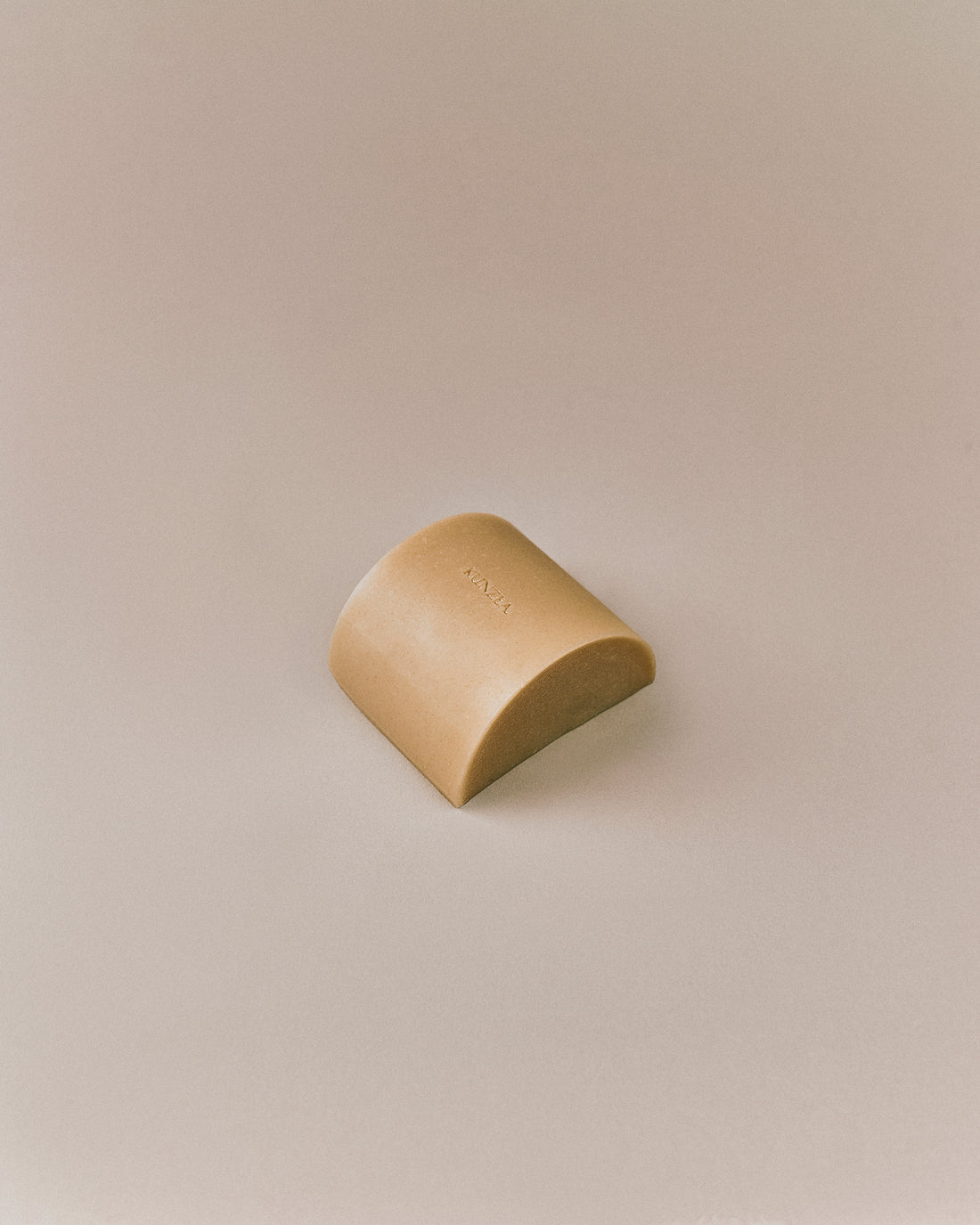Nhuka organic kunzea soap bar shown at an angle.  Organic cold processed soap for face and body, handmade with native botanicals and natural exfoliants.
