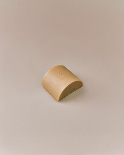 Nhuka organic kunzea soap bar shown at an angle.  Organic cold processed soap for face and body, handmade with native botanicals and natural exfoliants.