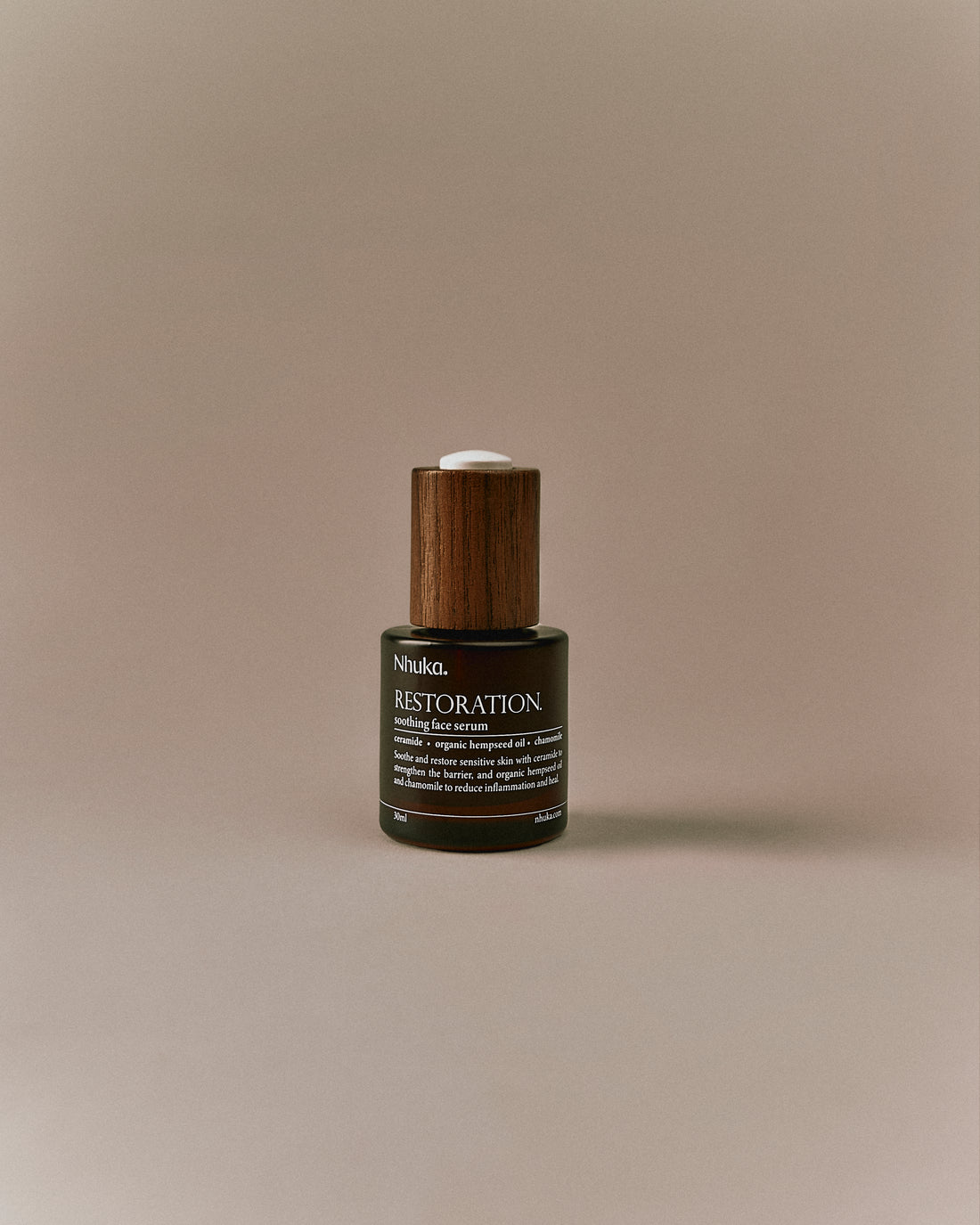 Nhuka Restoration Face Serum shown front on. A calming face serum with ceramides, organic hempseed oil, and rosehip to soothe irritation, strengthen the skin barrier, and hydrate sensitive or combination skin.