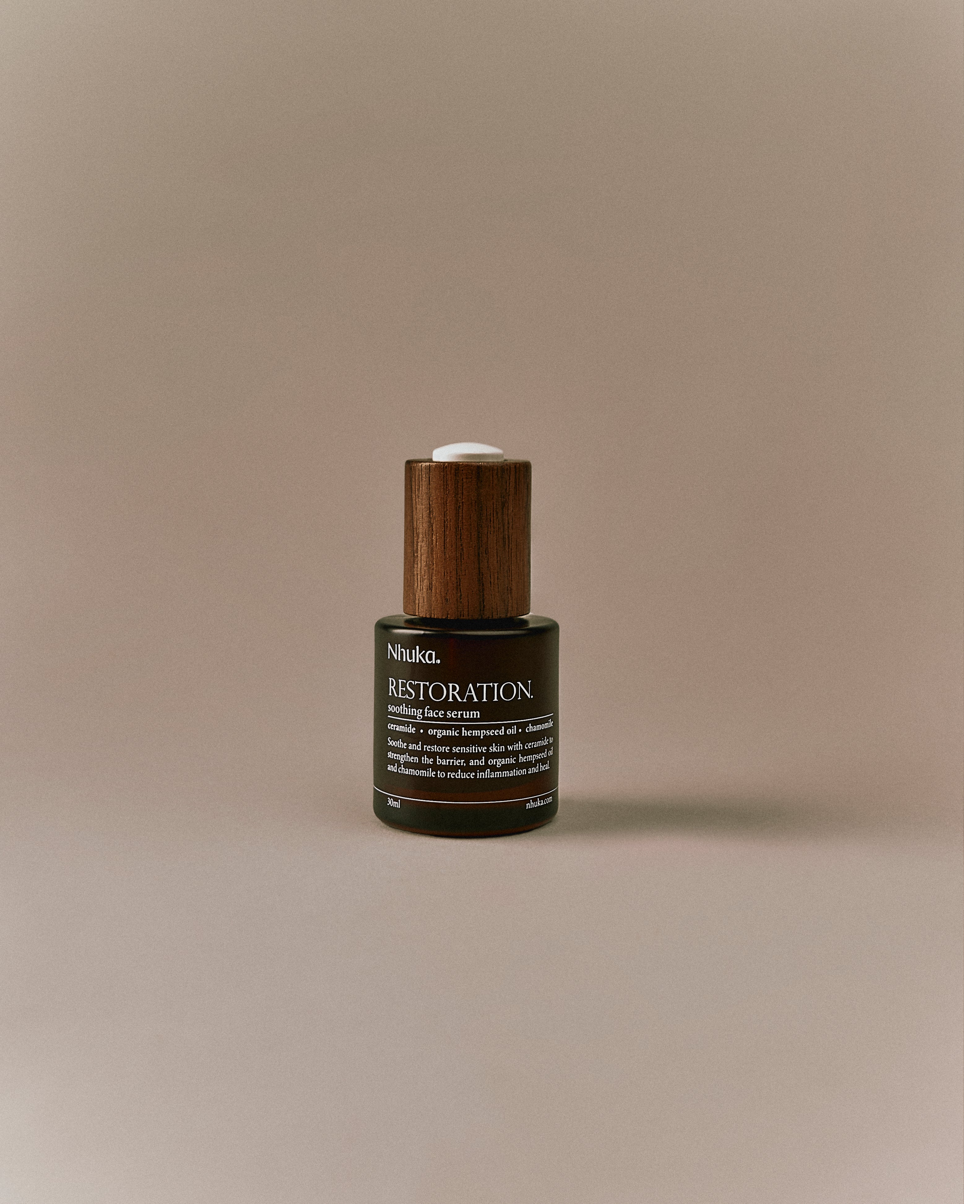 Nhuka Restoration Face Serum shown front on. A calming face serum with ceramides, organic hempseed oil, and rosehip to soothe irritation, strengthen the skin barrier, and hydrate sensitive or combination skin.