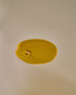 Nhuka Restoration Face Serum texture — golden oil droplets. Formulated with ceramides, hempseed, and rosehip oils to deliver calming hydration for sensitive skin.