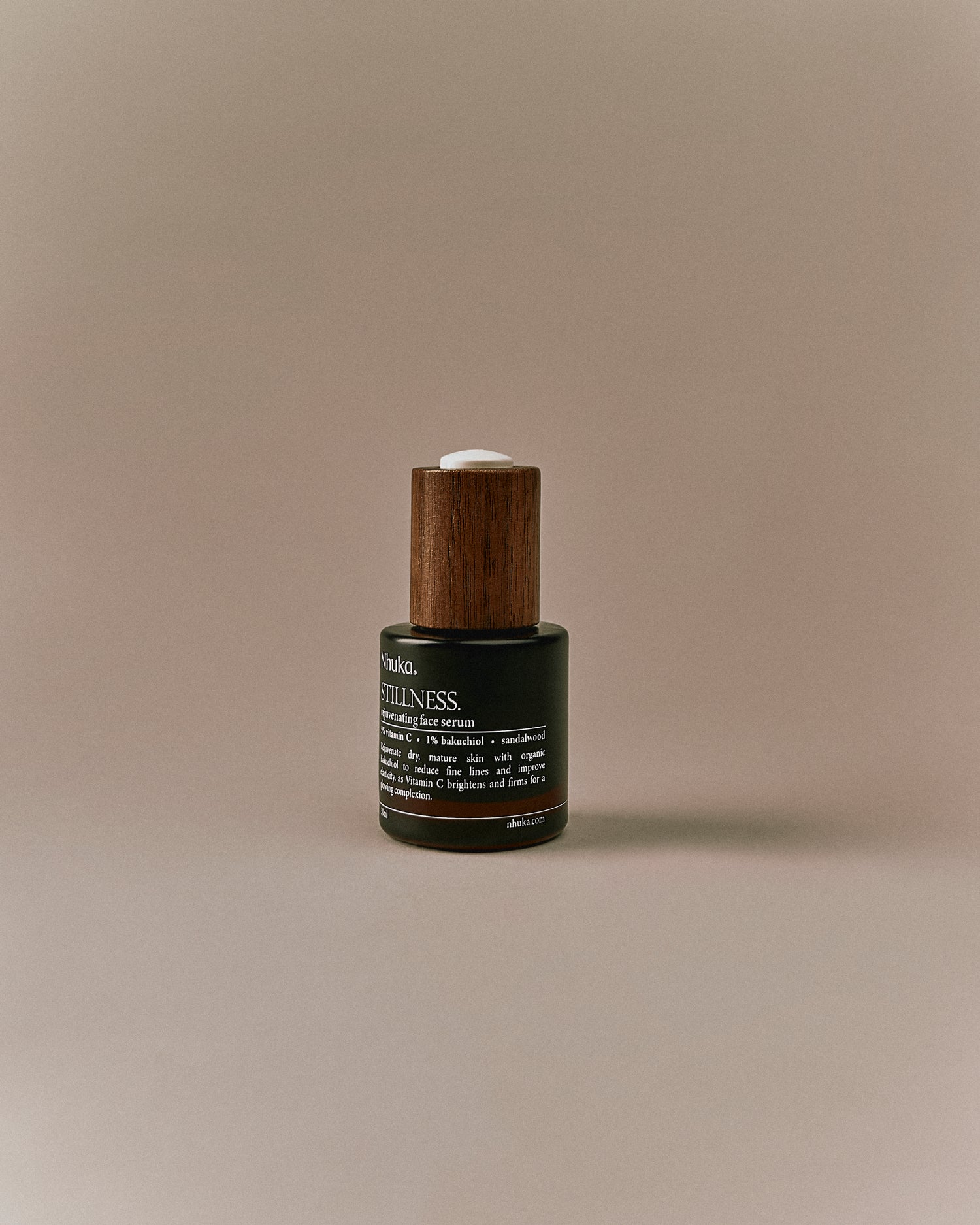 Nhuka Stillness Face Serum bottle with label visible. A rejuvenating serum with 1% bakuchiol oil and 5% vitamin C to support skin radiance and reduce fine lines. Handmade in Australia.