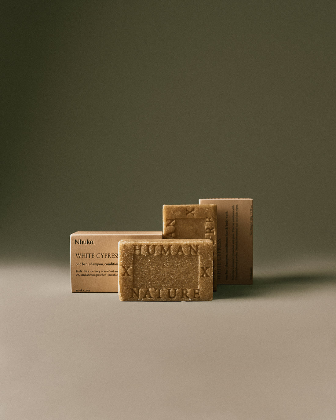 Nhuka White Cypress Organic One Bar with sandalwood powder scrub. Handmade in Australia, pH-balanced, sulfate-free, silicone-free, and organic. Scented with Australian native cypress and black pepper. Gently exfoliates while cleansing hair, face, and body.